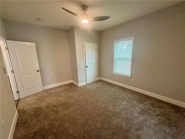 an empty room with windows and entrance