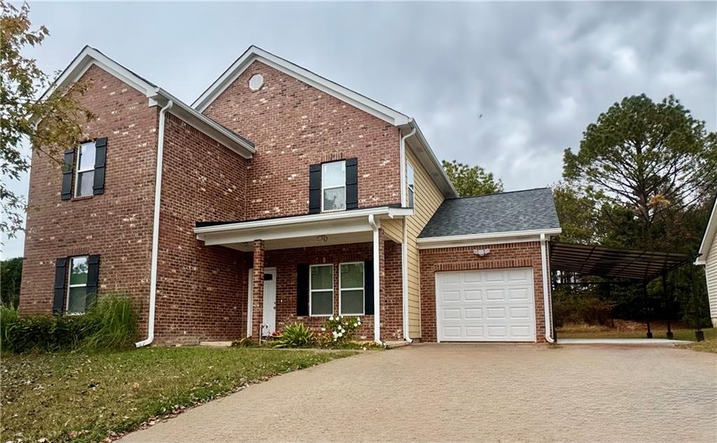 3700 Hudson Court Rex, GA 30273 - Photo 2 of 28 a front view of a house with a garden
