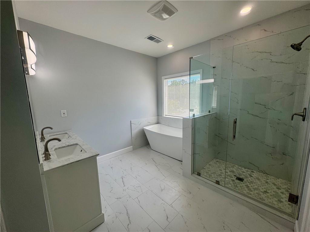 3700 Hudson Court Rex, GA 30273 - Photo 23 of 28 a bathroom with a bathtub and a shower