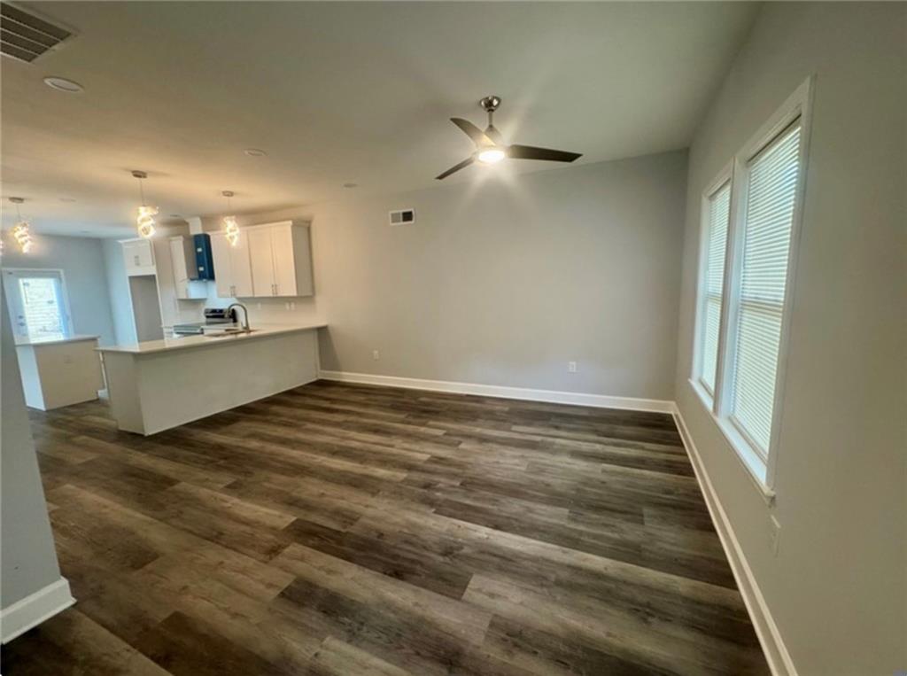 3700 Hudson Court Rex, GA 30273 - Photo 4 of 28 a view of kitchen and empty room with wooden floor