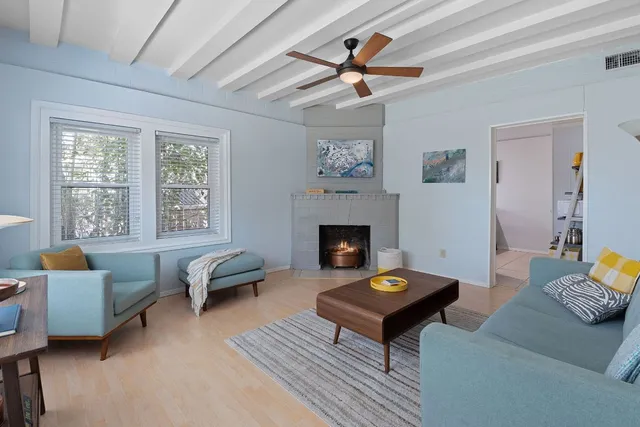 a living room with furniture a rug and a fireplace