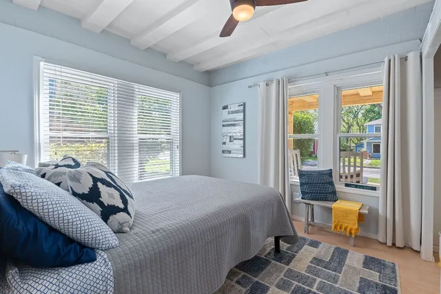 a bedroom with furniture and a window