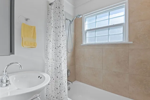 a bathroom with a bathtub and a sink