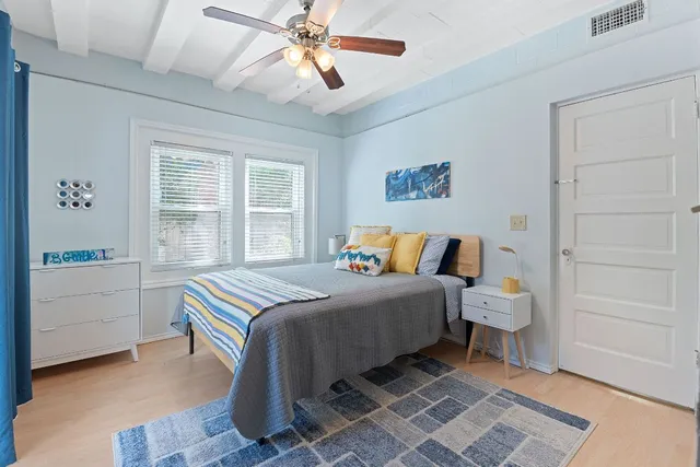 a bedroom with a bed and a window