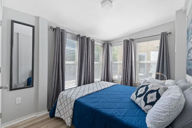 a bedroom with a bed and a window