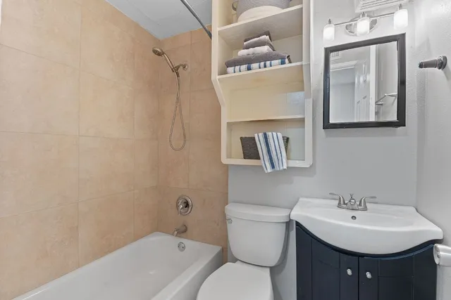a bathroom with a sink toilet and shower