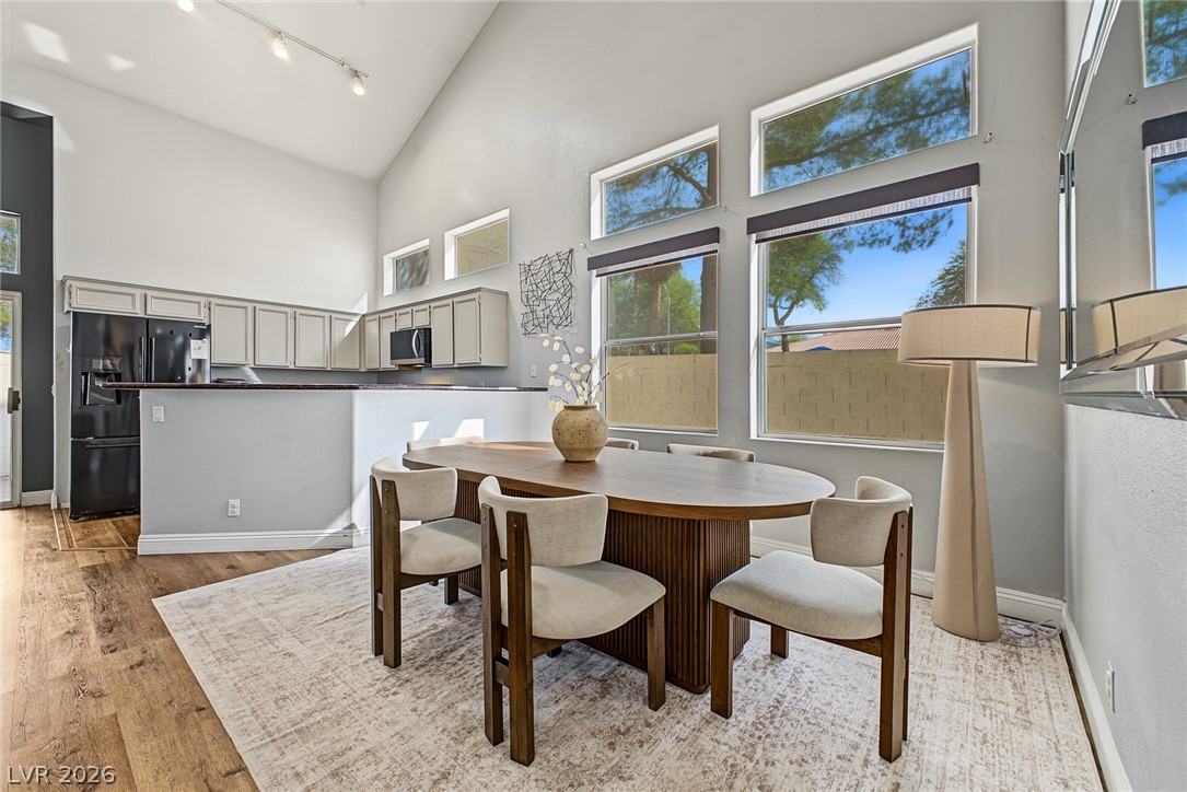2376 Ramsgate Drive Henderson, NV 89074 - Photo 12 of 25 Towering vaulted ceilings and tall windows elevate this open-concept dining space.
