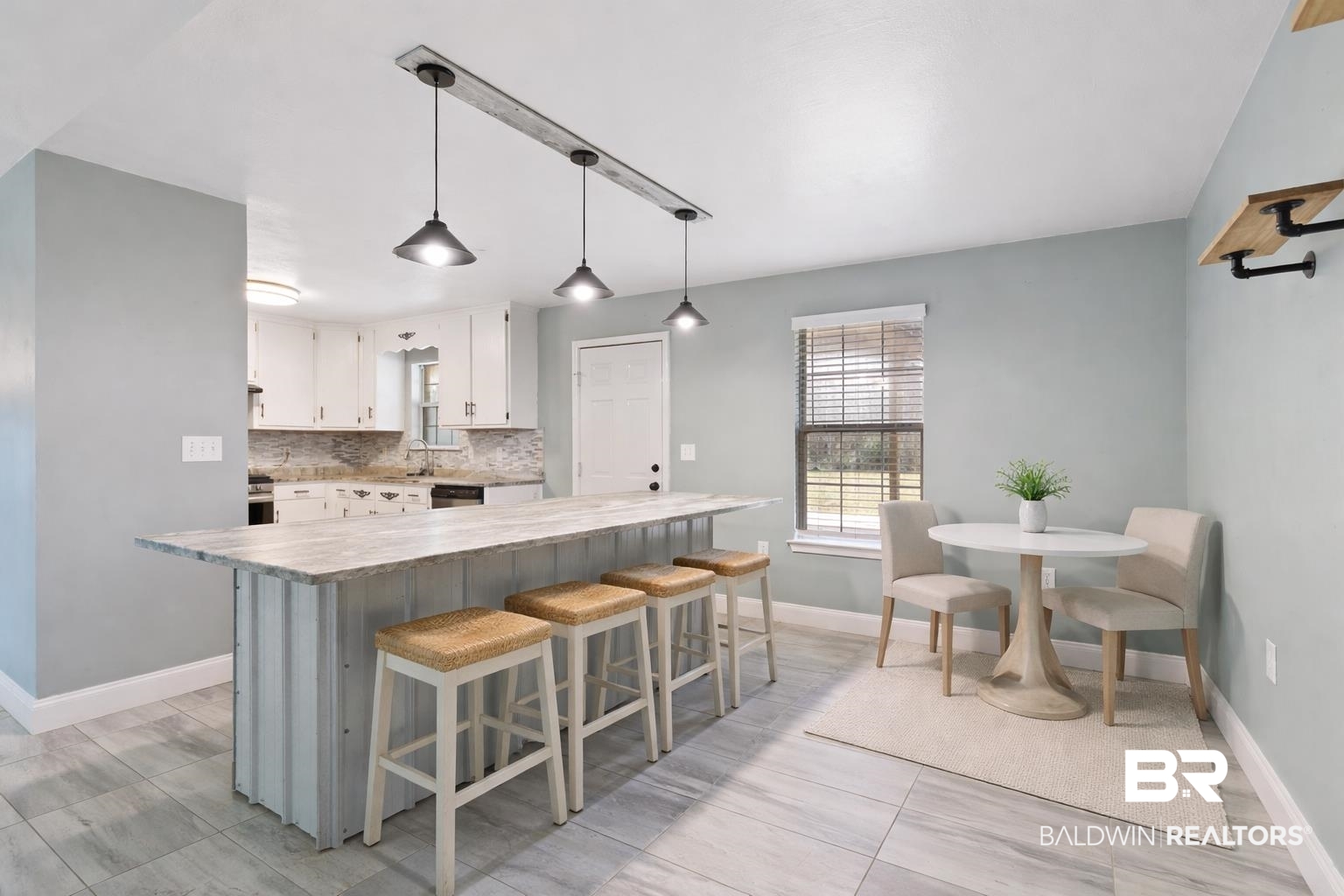 17366 Old Brady Road Bay Minette, AL 36507 - Photo 10 of 43 Kitchen featuring a breakfast bar area, a center island, pendant lighting, white cabinets, and decorative backsplash