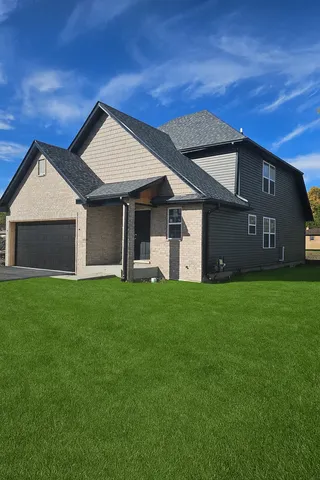 a view of a house with a yard