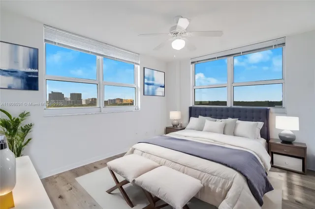 a bedroom with a large bed and a potted plant