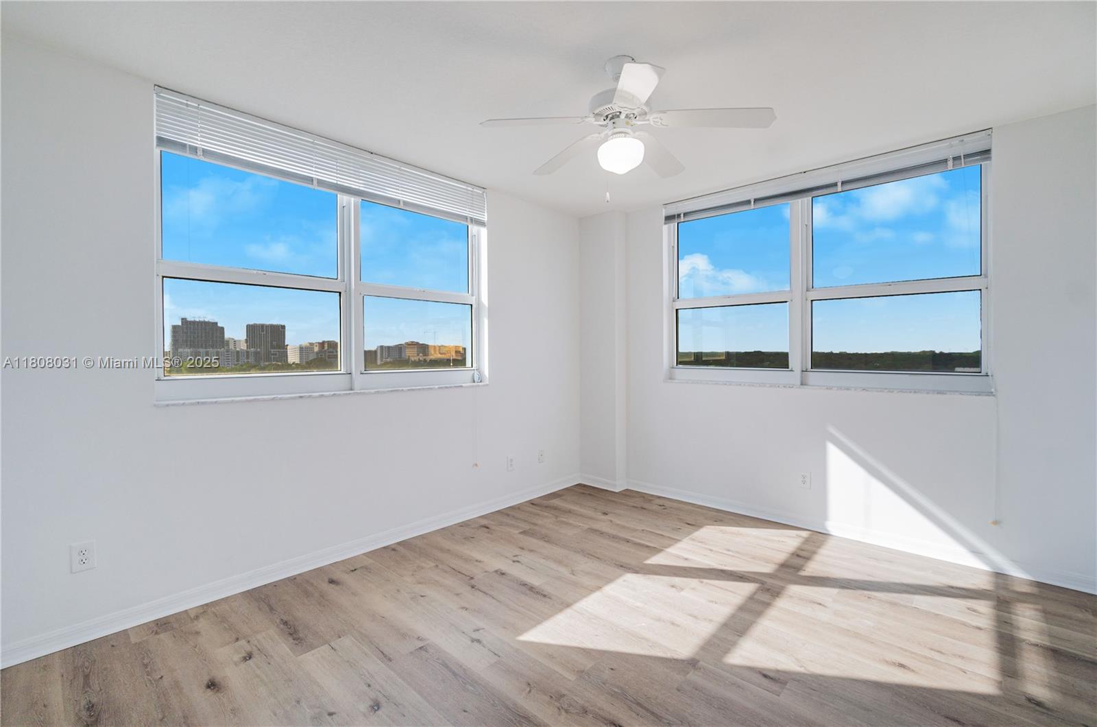 2665 Southwest 37th Avenue, Unit 906 Miami, FL 33133 - Photo 14 of 35 an empty room with wooden floor and windows