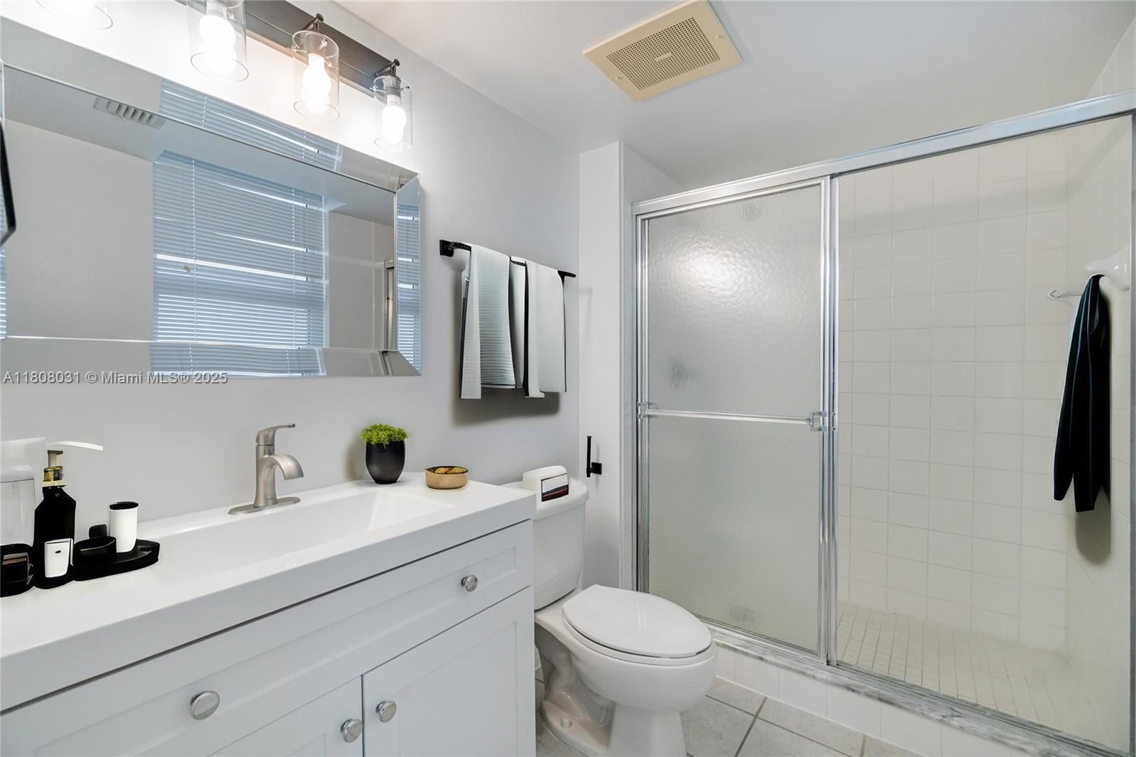 2665 Southwest 37th Avenue, Unit 906 Miami, FL 33133 - Photo 21 of 35 a bathroom with a sink toilet and shower