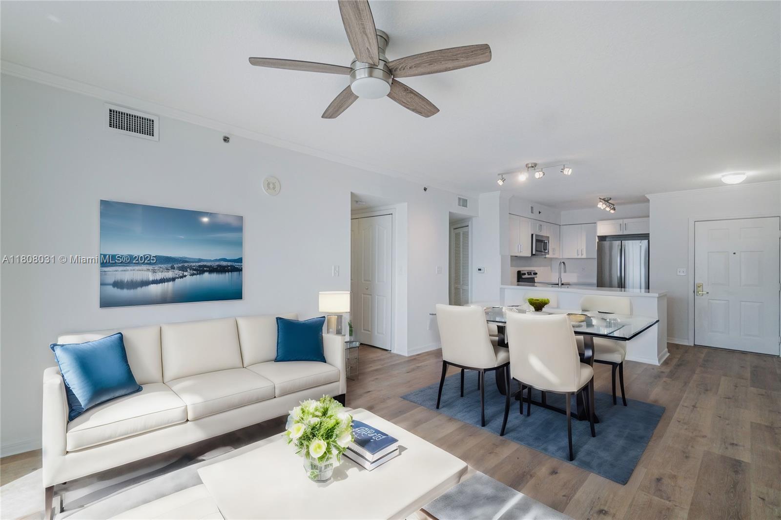 2665 Southwest 37th Avenue, Unit 906 Miami, FL 33133 - Photo 7 of 35 a living room with furniture a ceiling fan and a rug