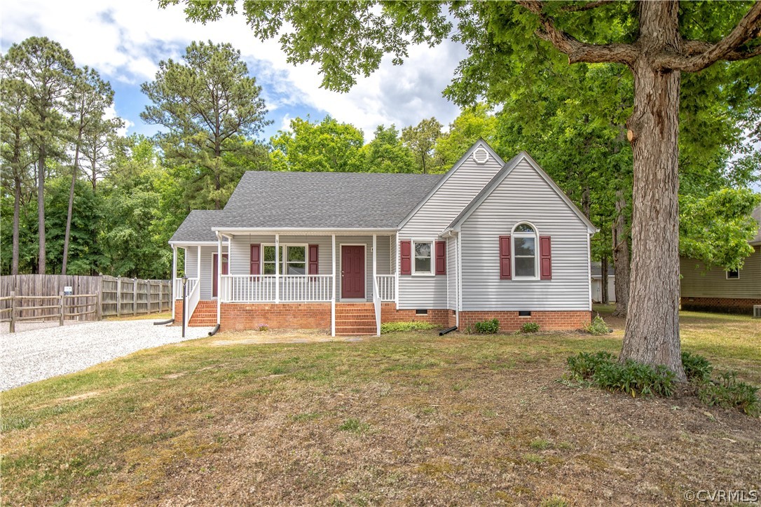 7344 Trailing Rock Road Prince George, VA 23875 - Photo 1 of 25 a front view of a house with a yard