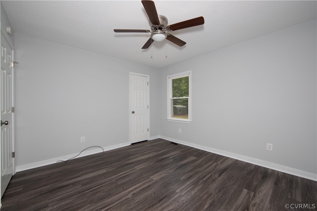 7344 Trailing Rock Road Prince George, VA 23875 - Photo 17 of 25 an empty room with wooden floor fan and windows
