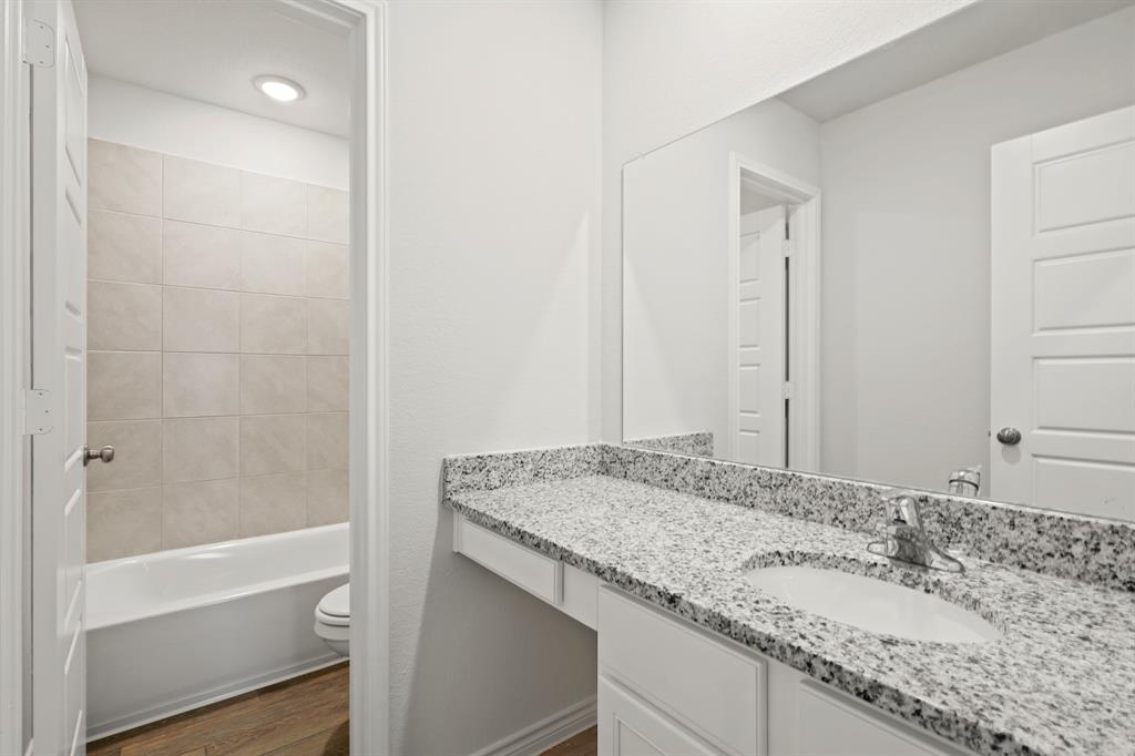 1600 Romans Road Ennis, TX 75119 - Photo 14 of 19 a bathroom with a granite countertop sink and a mirror