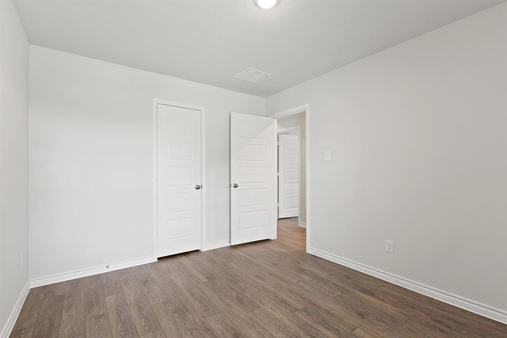 1600 Romans Road Ennis, TX 75119 - Photo 17 of 19 a view of an empty room with wooden floor