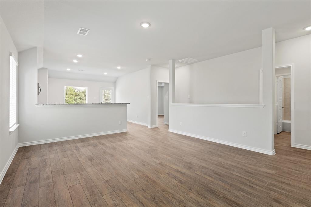 1600 Romans Road Ennis, TX 75119 - Photo 6 of 19 a view of an empty room with wooden floor and a window