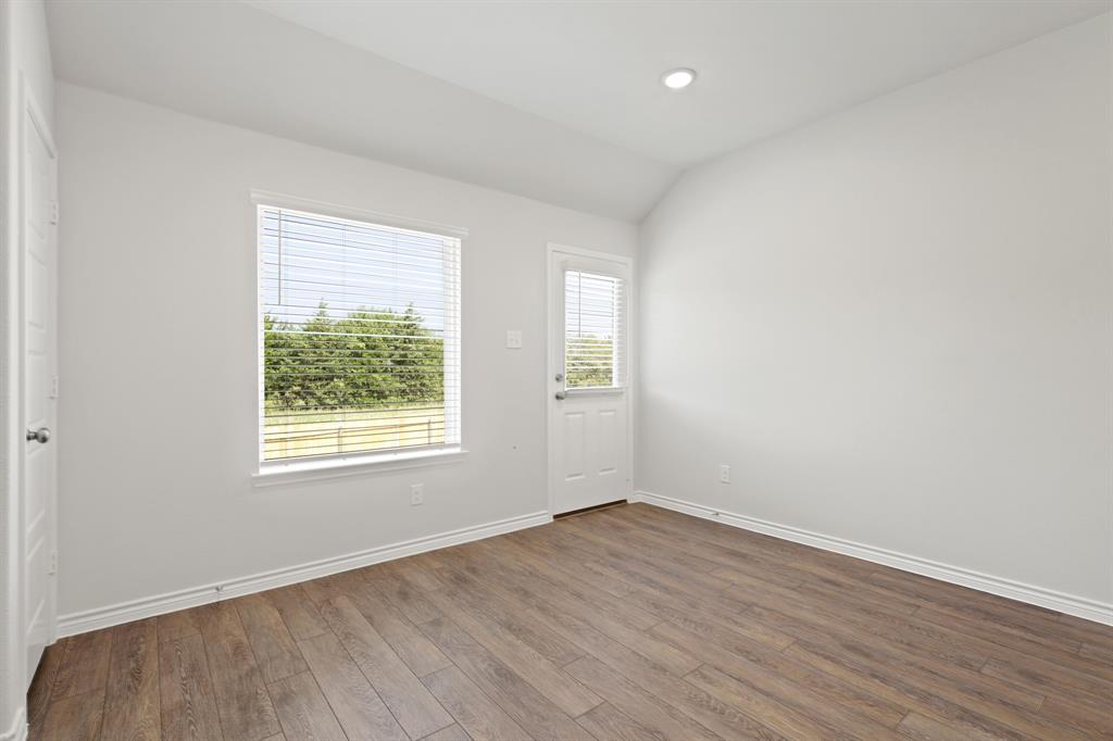 1600 Romans Road Ennis, TX 75119 - Photo 7 of 19 an empty room with wooden floor and windows