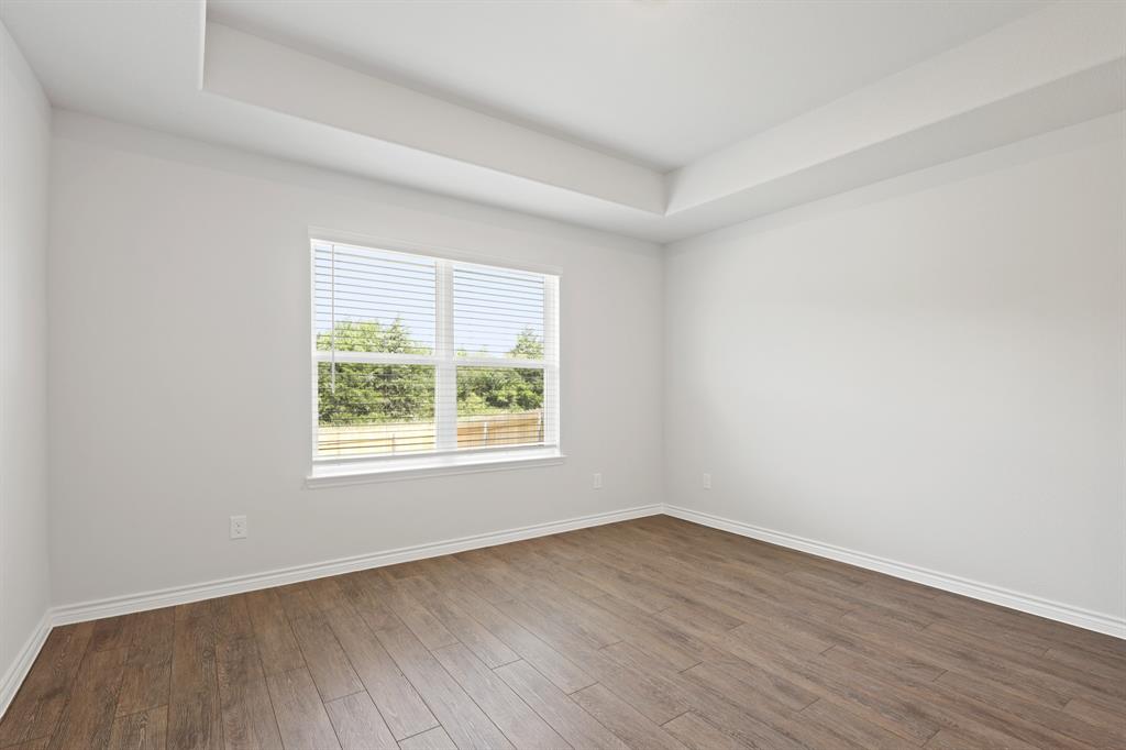 1600 Romans Road Ennis, TX 75119 - Photo 9 of 19 an empty room with wooden floor and windows