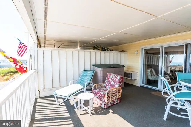 a dining room with furniture and floor to ceiling window