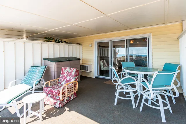 a view of a dining room with furniture and a window
