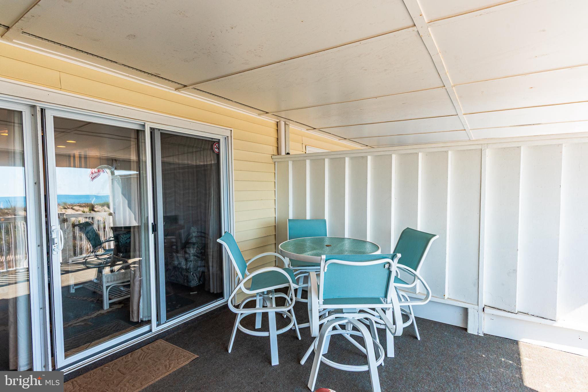 7601 Atlantic Avenue, Unit 3 Ocean City, MD 21842 - Photo 20 of 52 a dining room with furniture and floor to ceiling window
