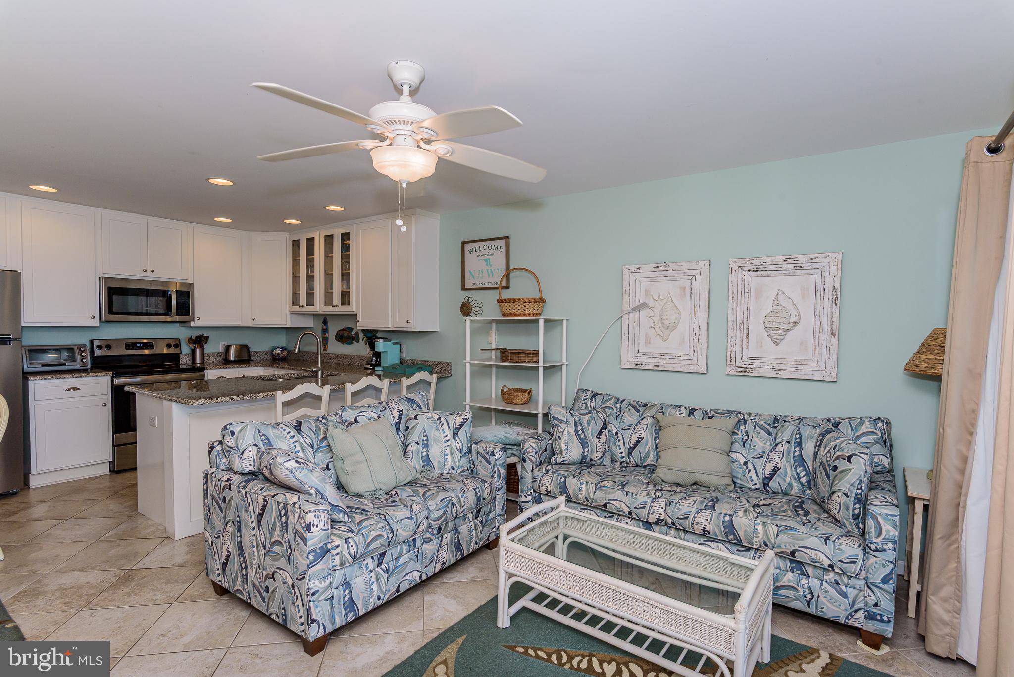 7601 Atlantic Avenue, Unit 3 Ocean City, MD 21842 - Photo 30 of 52 a living room with furniture and a chandelier