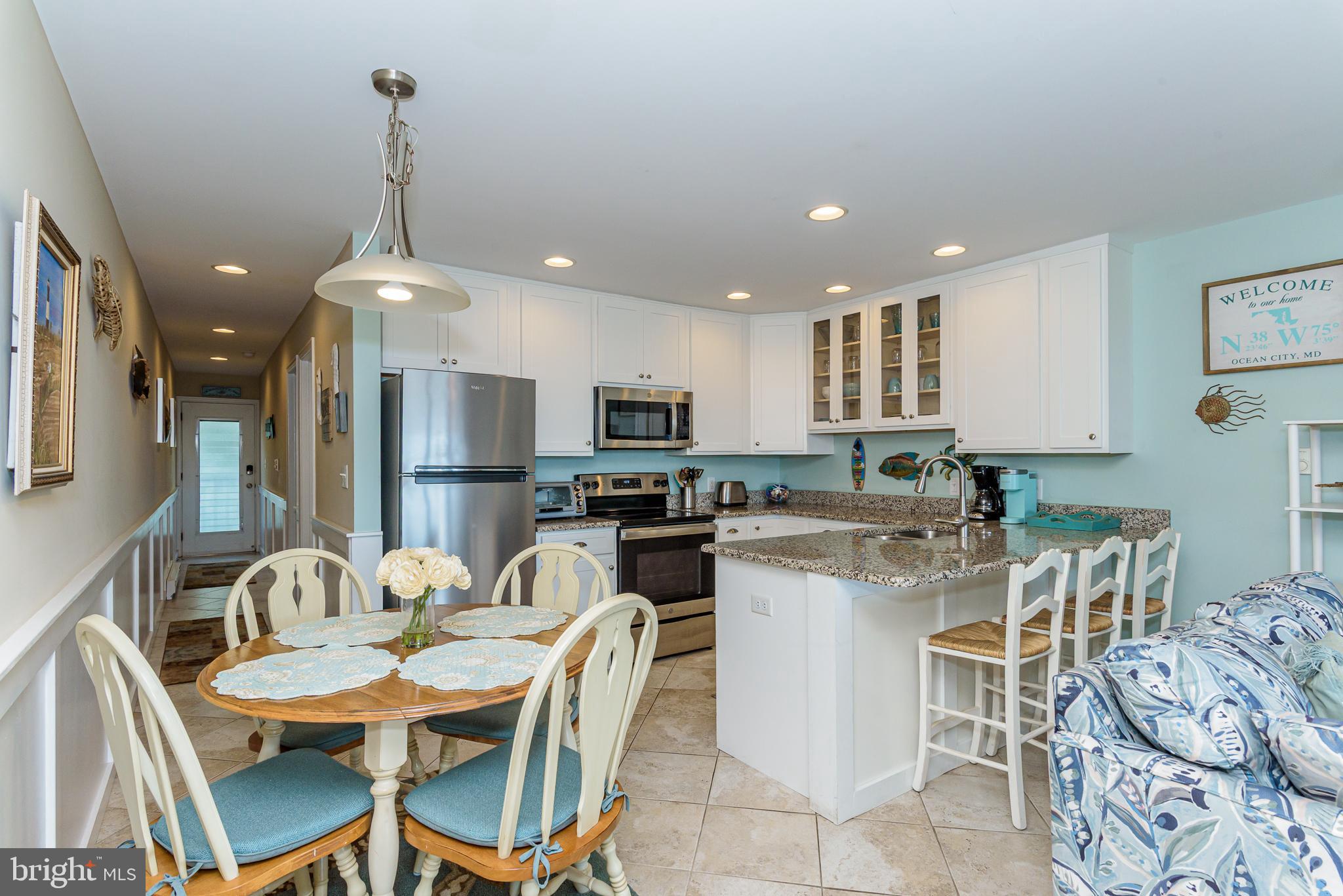7601 Atlantic Avenue, Unit 3 Ocean City, MD 21842 - Photo 36 of 52 a large kitchen with a table and chairs