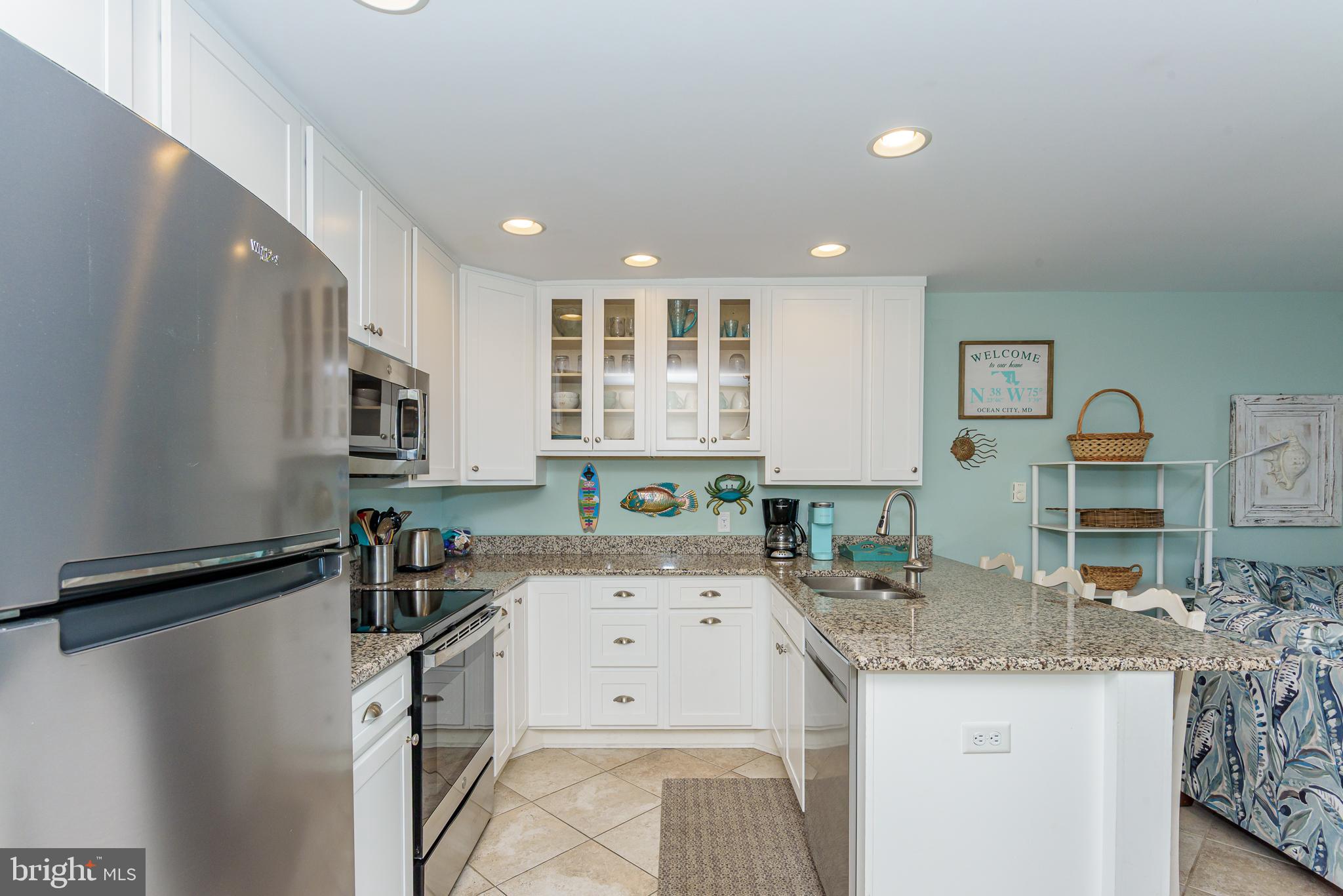 7601 Atlantic Avenue, Unit 3 Ocean City, MD 21842 - Photo 40 of 52 a kitchen with a sink stove and cabinets