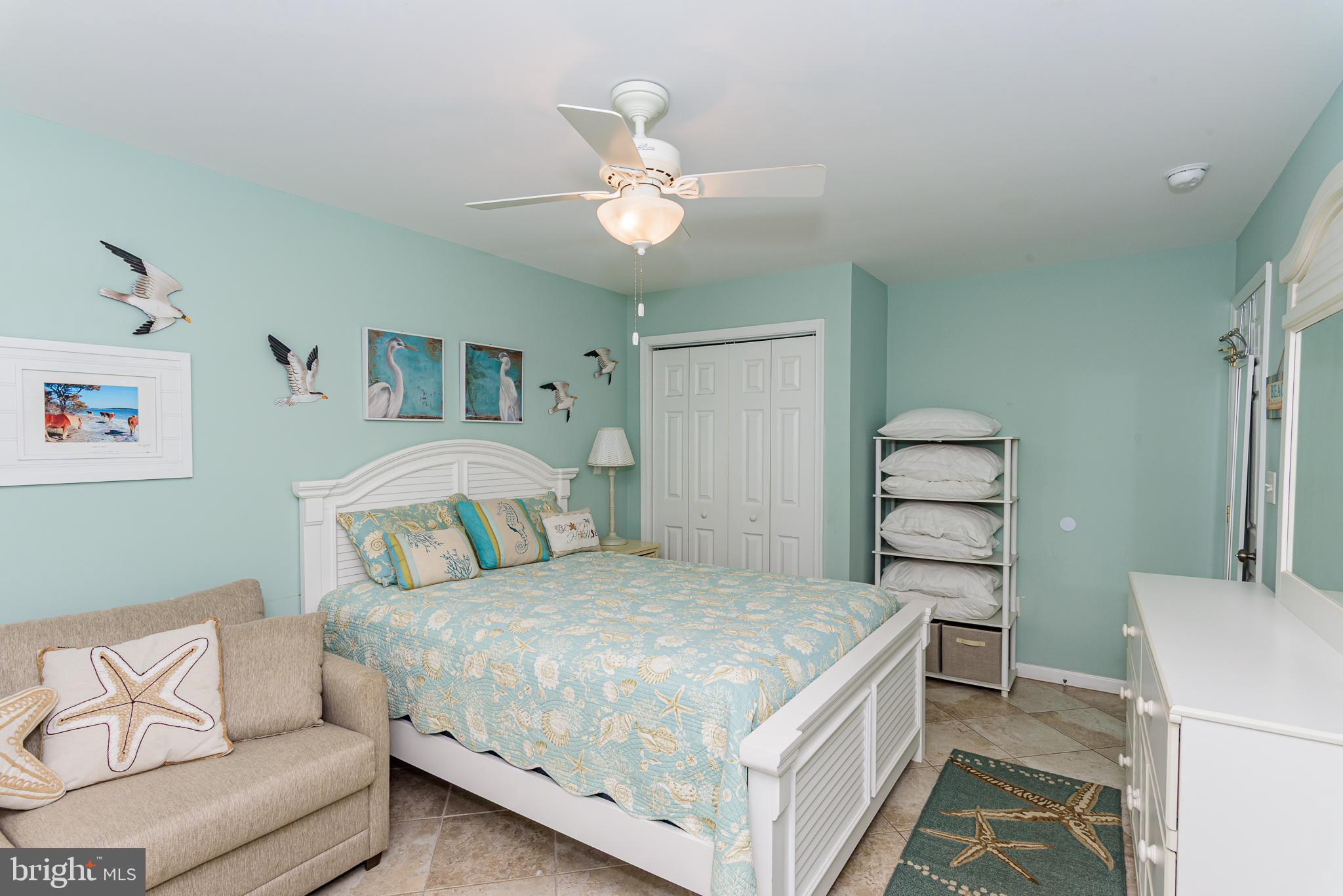 7601 Atlantic Avenue, Unit 3 Ocean City, MD 21842 - Photo 41 of 52 a bedroom with a bed and a couch