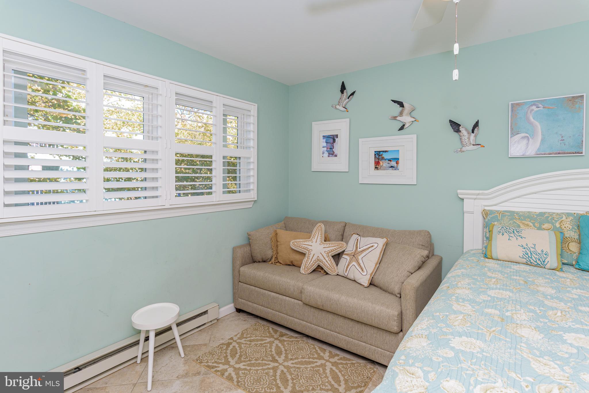 7601 Atlantic Avenue, Unit 3 Ocean City, MD 21842 - Photo 44 of 52 a living room with furniture and a window