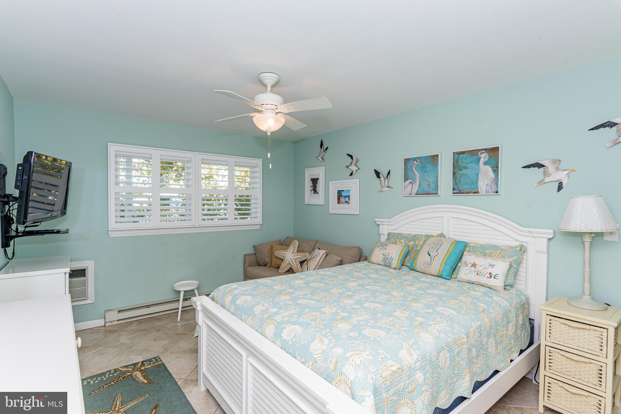 7601 Atlantic Avenue, Unit 3 Ocean City, MD 21842 - Photo 46 of 52 a bedroom with a large bed and a window