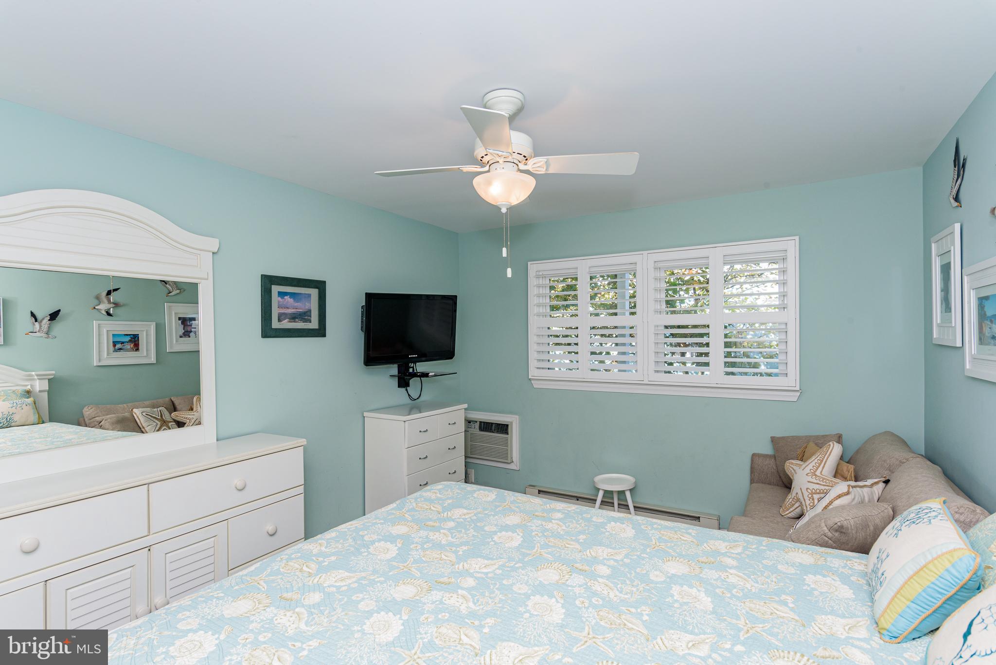 7601 Atlantic Avenue, Unit 3 Ocean City, MD 21842 - Photo 47 of 52 a bedroom with a bed and a flat screen tv