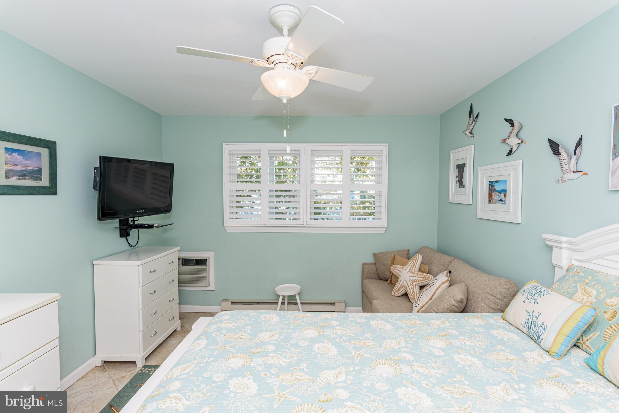 7601 Atlantic Avenue, Unit 3 Ocean City, MD 21842 - Photo 48 of 52 a bedroom with a bed and a flat screen tv