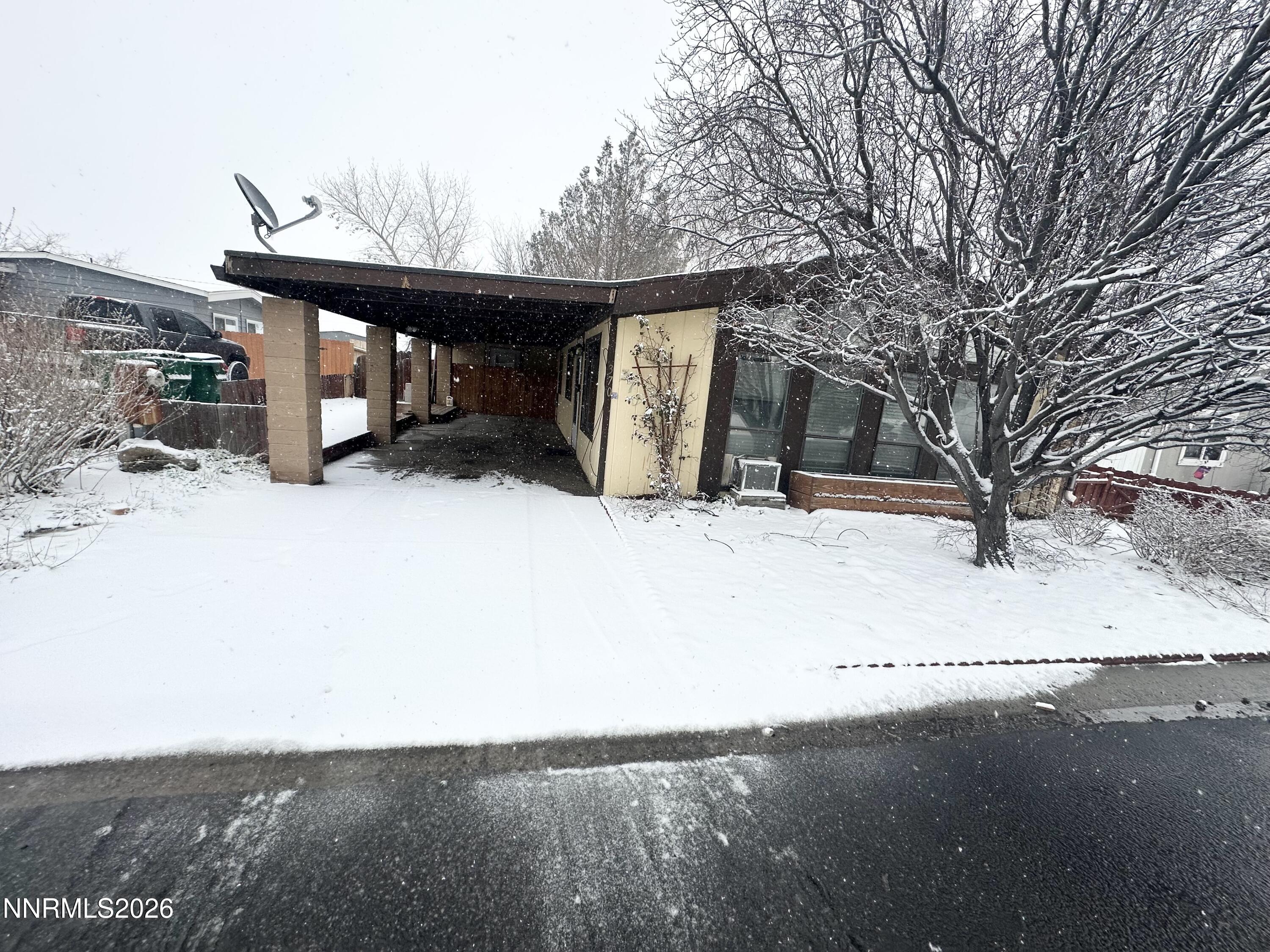 a view of a house with a snow in the yard