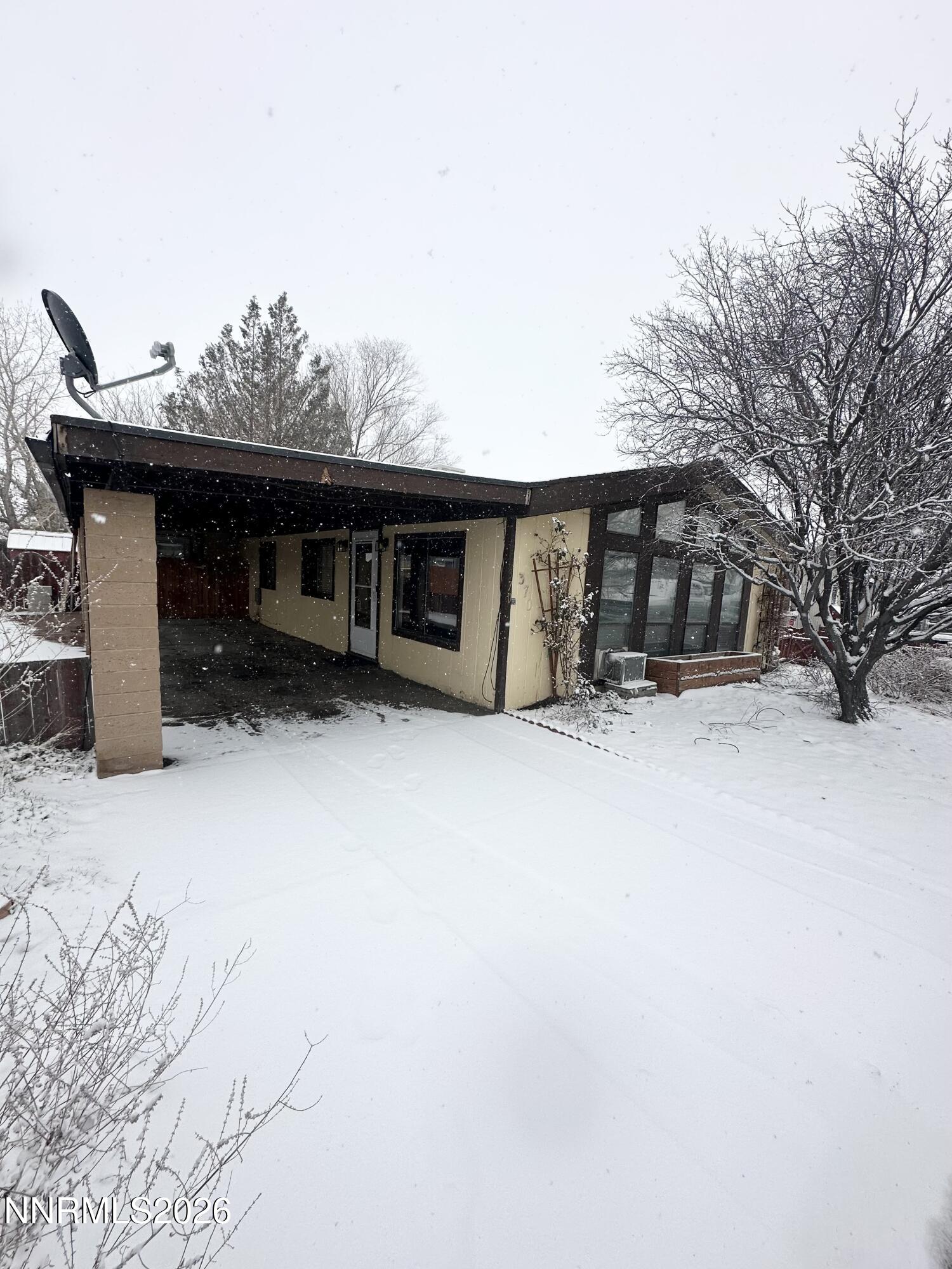 370 Randon Court Fernley, NV 89408 - Photo 2 of 15 a view of a house with a yard covered in snow