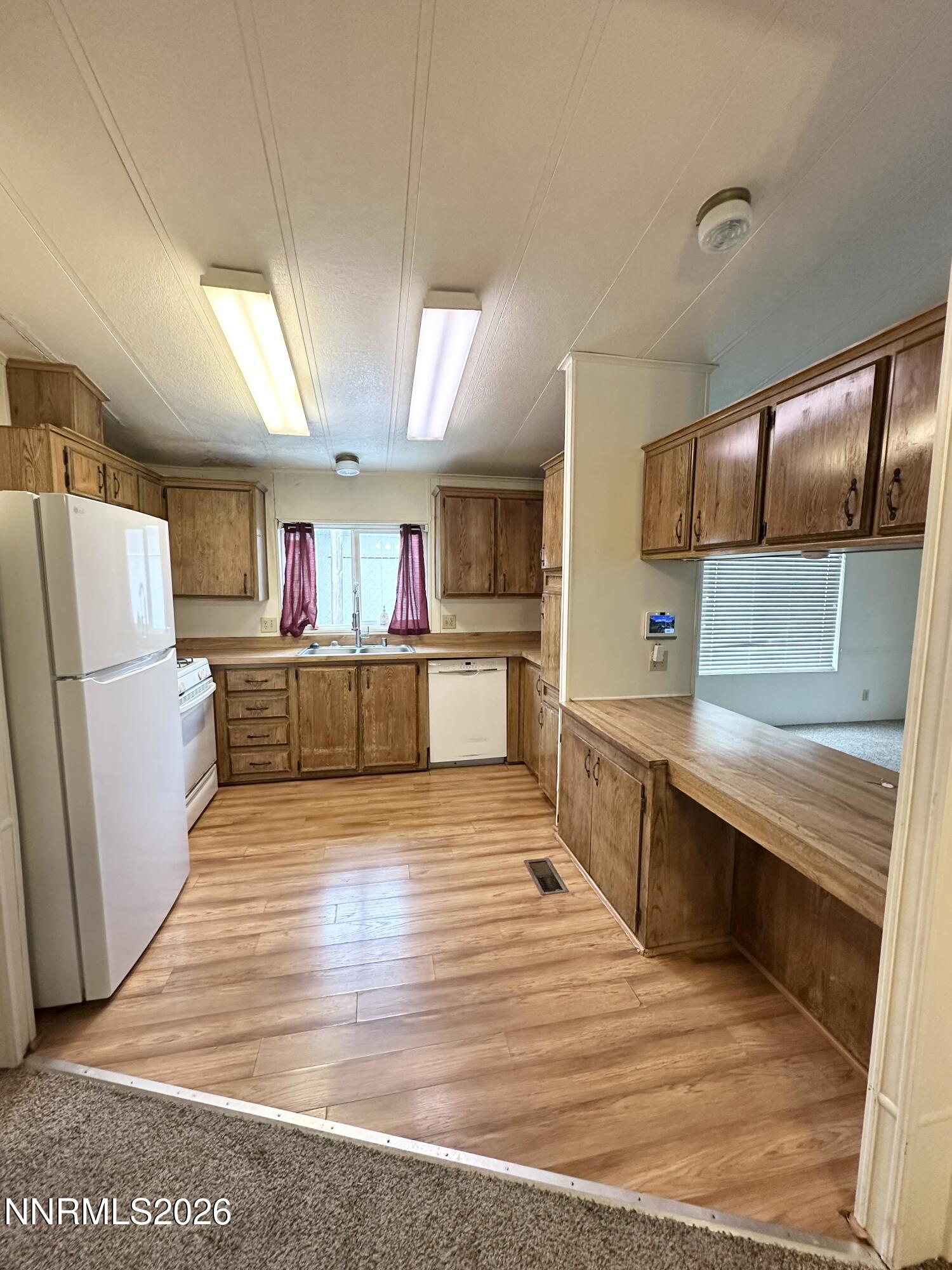 370 Randon Court Fernley, NV 89408 - Photo 5 of 15 a large kitchen with stainless steel appliances wooden floor and a counter top space