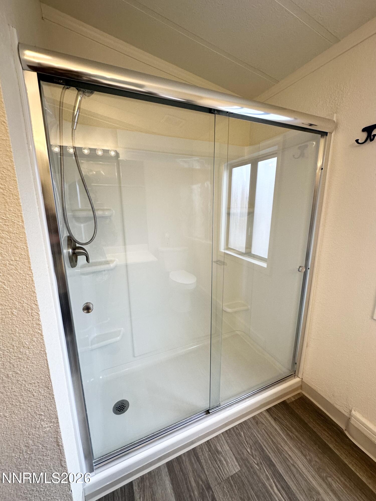 370 Randon Court Fernley, NV 89408 - Photo 10 of 15 a bathroom with a glass shower door
