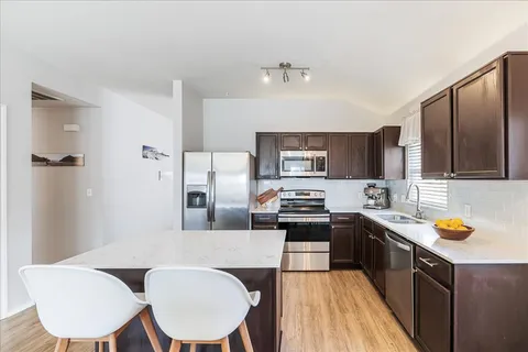 a kitchen with stainless steel appliances a stove sink and microwave