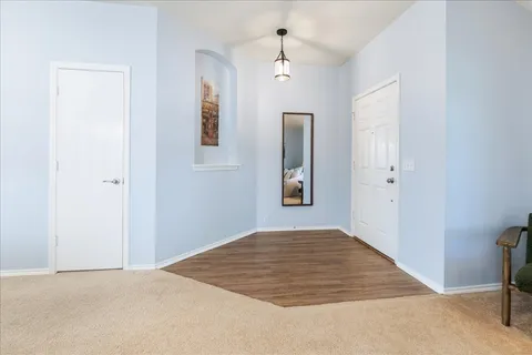 a view of a room with window and hardwood floor