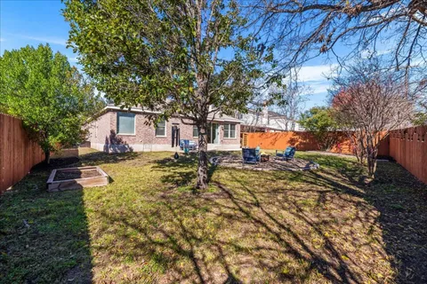 a view of a house with backyard and sitting area