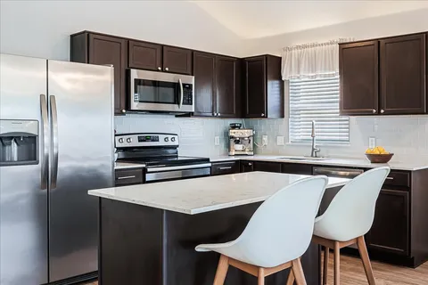 a kitchen with a sink stove and cabinets