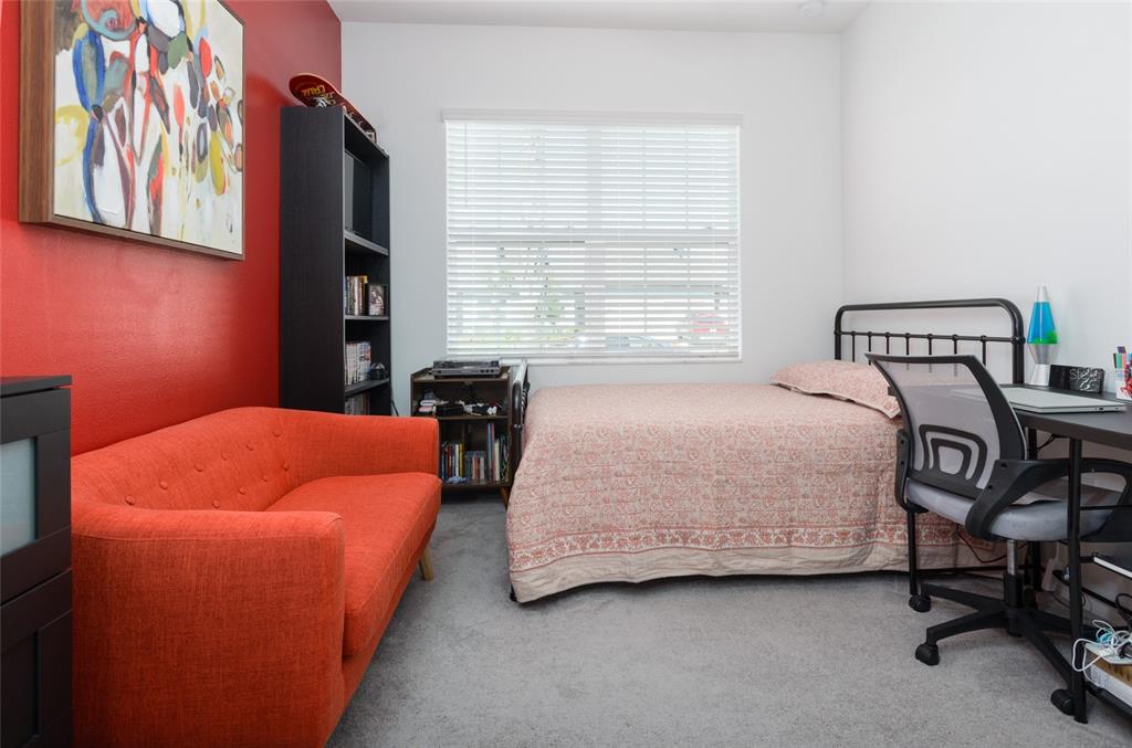 6736 Ripple Pond Loop Zephyrhills, FL 33541 - Photo 7 of 40 a bedroom with a bed and a couch