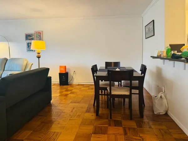 a kitchen with white cabinets and black appliances