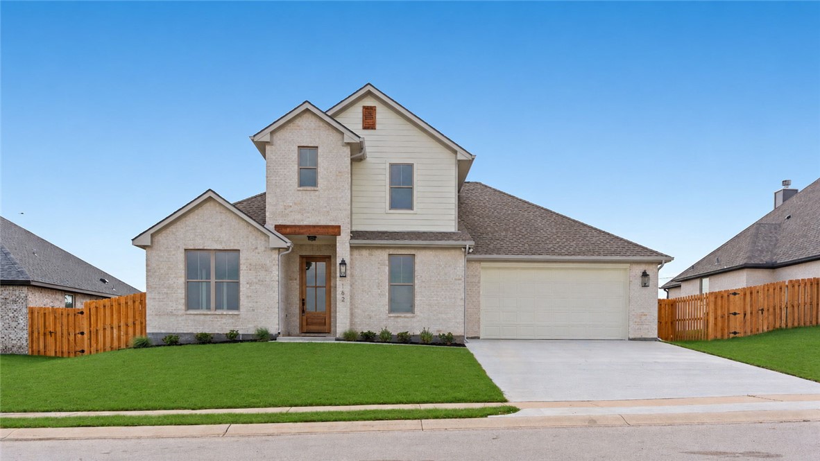 162 Buffalo Rdg Road Giddings, TX 78942 - Photo 1 of 31 a front view of a house with a yard and garage