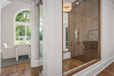 a bedroom with furniture and a large window