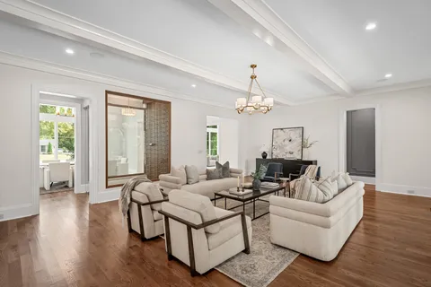 a living room with furniture and a chandelier