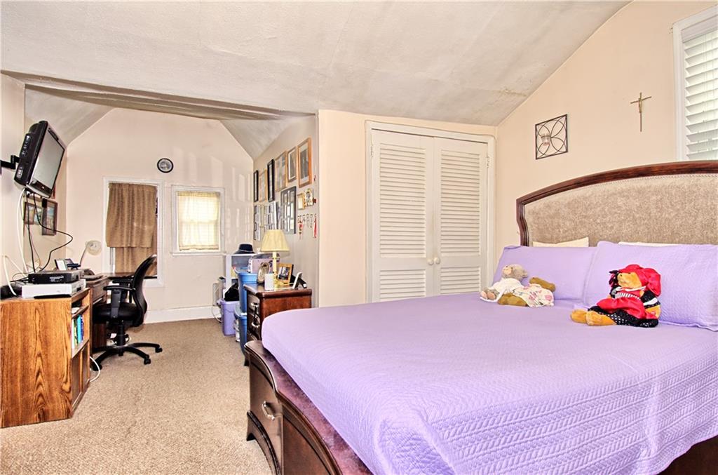 8800 19th Avenue Brooklyn, NY 11214 - Photo 13 of 26 a bedroom with a bed and wooden floor