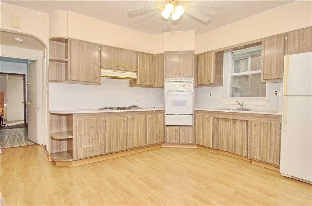 8800 19th Avenue Brooklyn, NY 11214 - Photo 3 of 26 a kitchen with white cabinets and sink